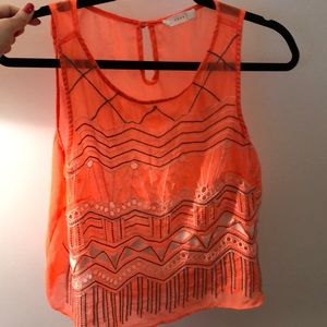 Bright orange sheer pattern cut out tank